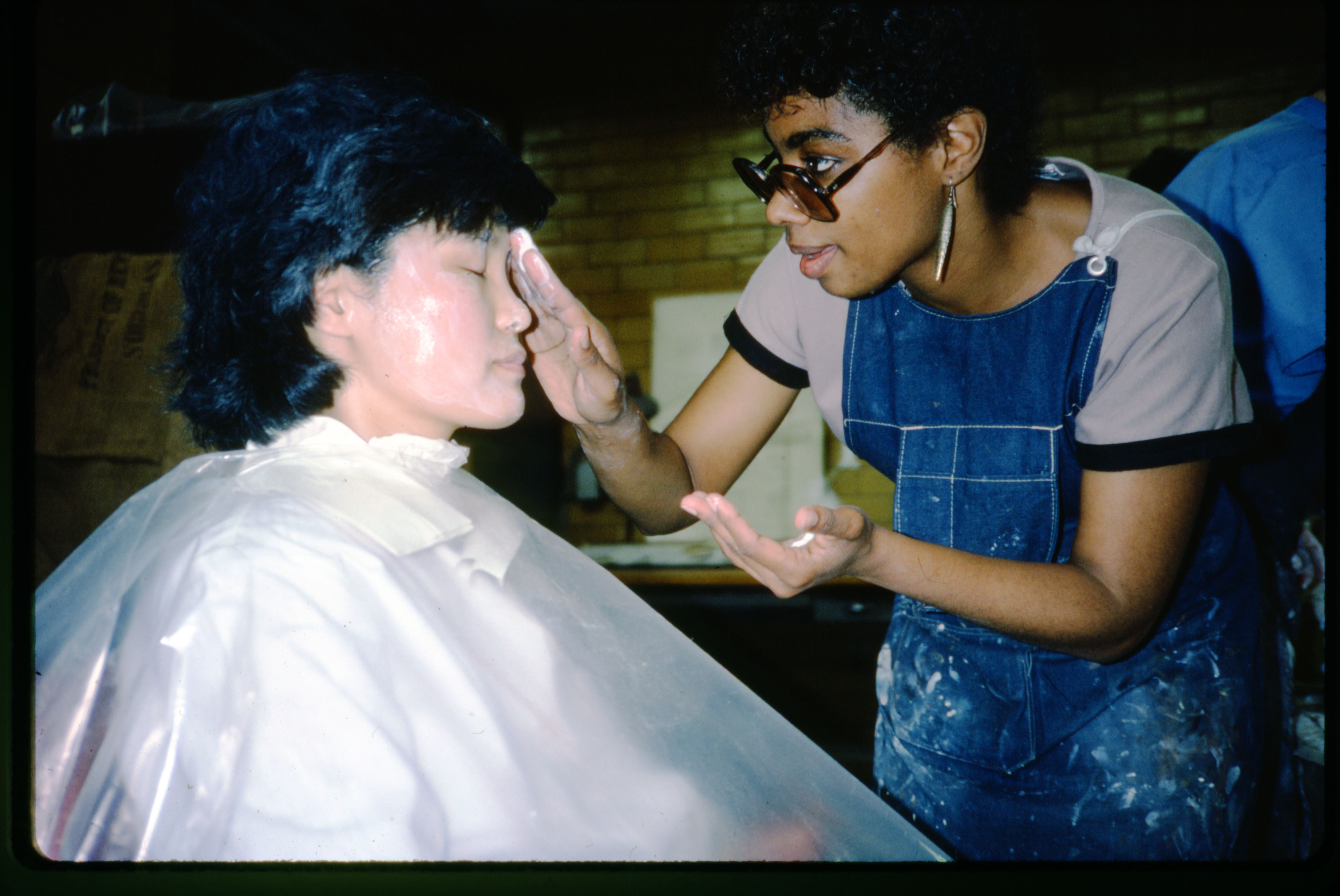 Patricia Harrison, senior preparator at AMNH, applies moisturizer to Chong-Hwa Lim’s face in preparation for making the mold.