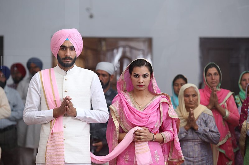 A 2019 Sikh wedding celebration.  “Indian Wedding Celebration”  Benipal hardarshan, 2019, CC-BY-SA-3.0